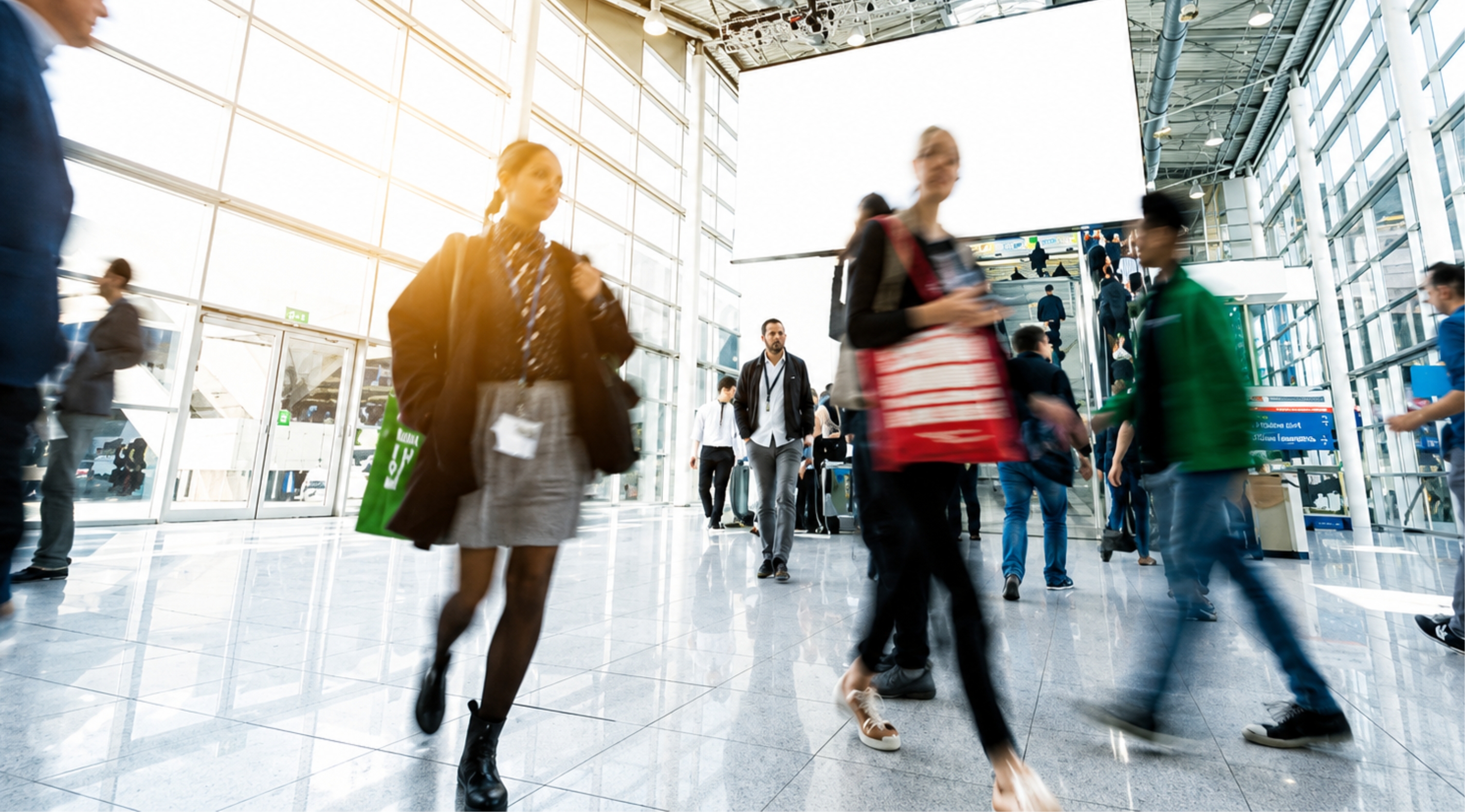 Delegates walking through a bright exhibition hall