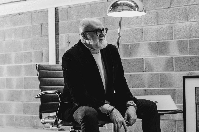 David Turner seated beside a framed Subway storefront photograph