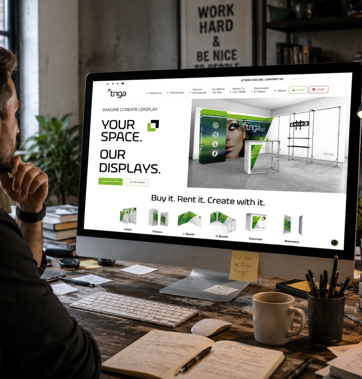 Designer reviewing the Triga Go website at a studio desk
